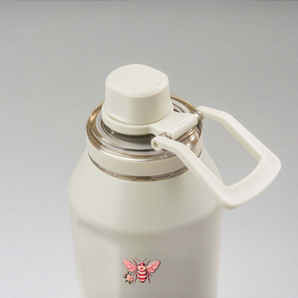 Garrafa Térmica PACCO Vyta 1200ml Rosé Romântico Creme, vista de cima com a alça de lado