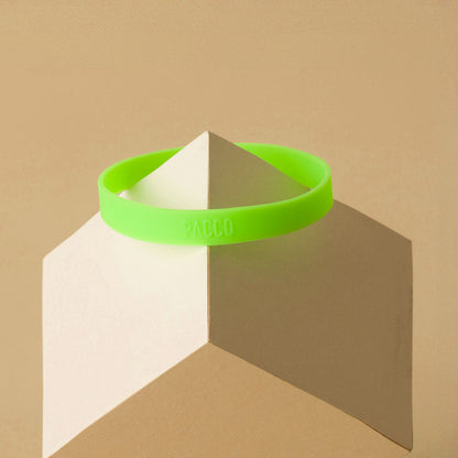Anel de Silicone PACCO em verde vibrante sobre base geométrica para estilo e ergonomia.
