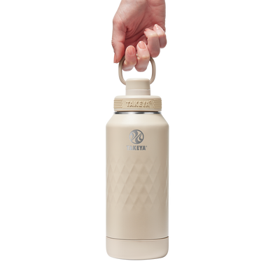 Garrafa Térmica Takeya 950ml Spout Lid Sport portátil em mãos, ideal para esportes e atividades intensas com alta capacidade térmica.