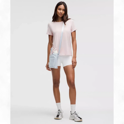 Modelo usando a Bolsa para Garrafa Térmica - Cross Bottle Lululemon, leve e prática para garrafas, celular e chaves.