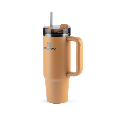 Copo Quencher Stanley 887ml com isolamento térmico e alça ergonômica em cor bege, mantém bebida gelada por até 40 horas com gelo.