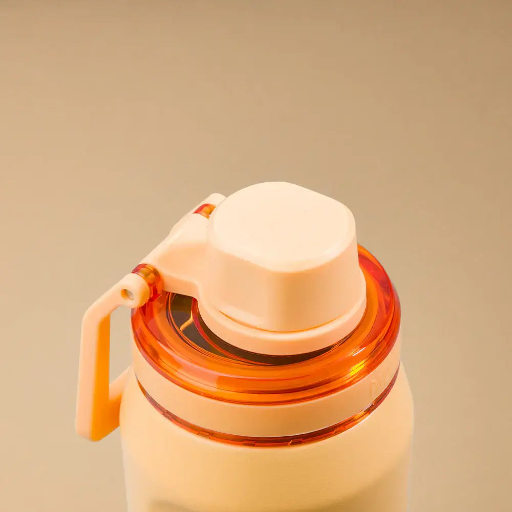 Garrafa Térmica PACCO Vyta 650ml com design elegante e tampo laranja, ideal para manter bebidas quentes e frias por horas.
